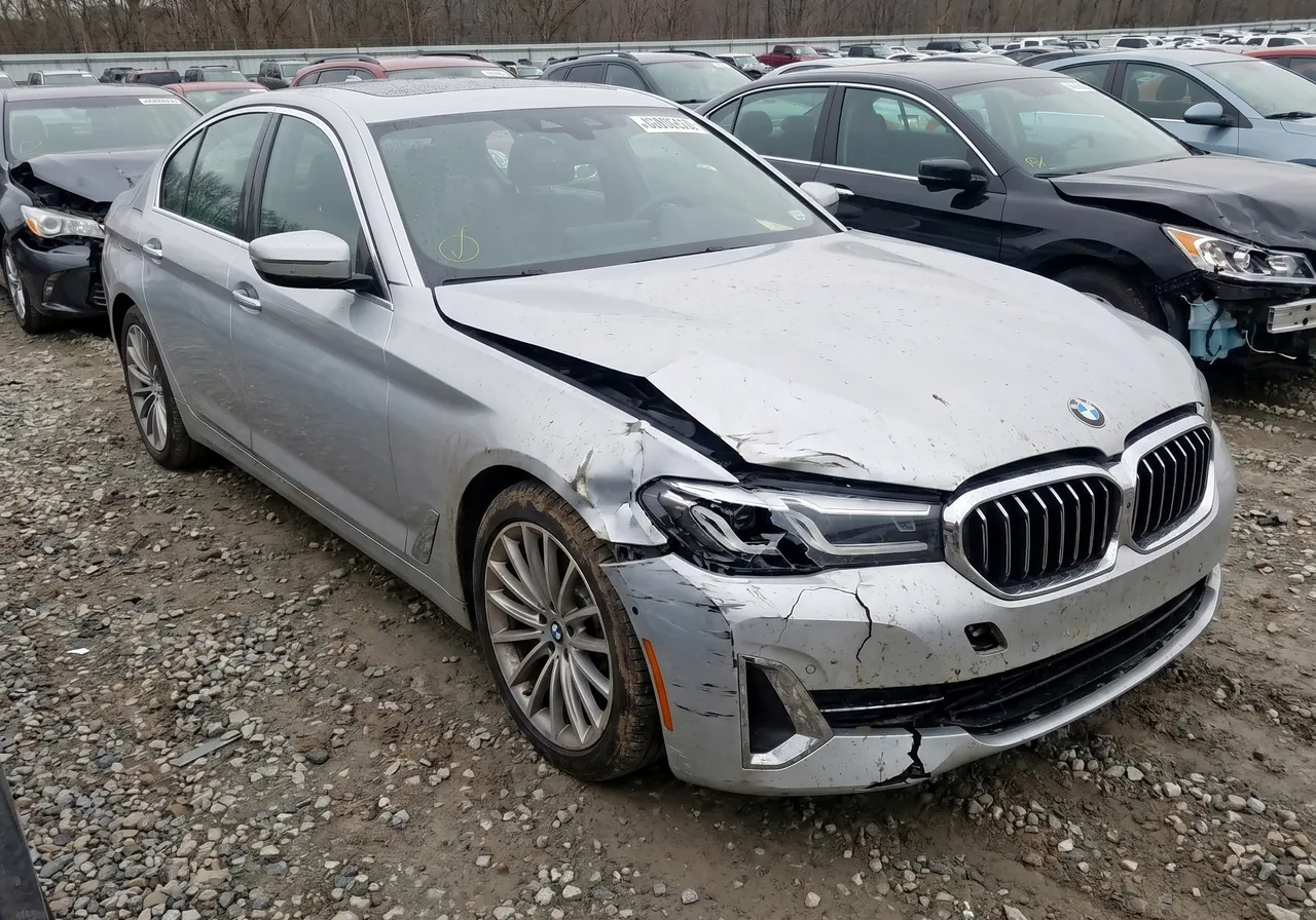 A silver BMW 5 Series with front-end collision damage as found at the auction, before reconditioning